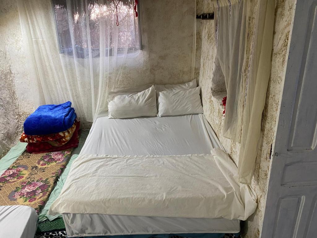 Postel nebo postele na pokoji v ubytování Maison d'hotes oued el Makhazine chez Bilal