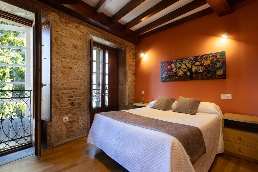a bedroom with a large bed and a window at PR Badalada in Santiago de Compostela
