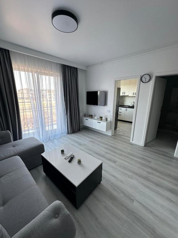 un salon avec un canapé et une table basse dans l'établissement Affordable Cute & Comfy Flat, à Dobroeşti