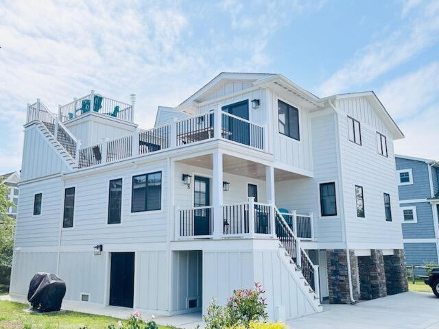 a large white house with a balcony on top of it at Sea side drive 8 in Bethany Beach
