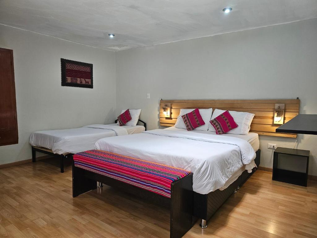 Ένα ή περισσότερα κρεβάτια σε δωμάτιο στο Xplora Hostel Cusco