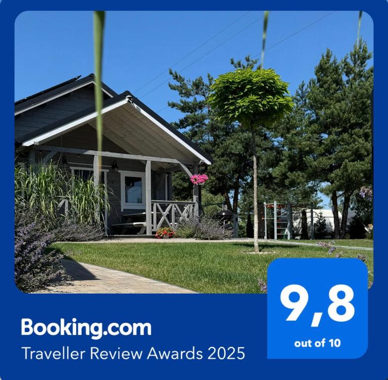 a house with a sign that says travel review awards at Przystanek Prawdowo in Mikołajki