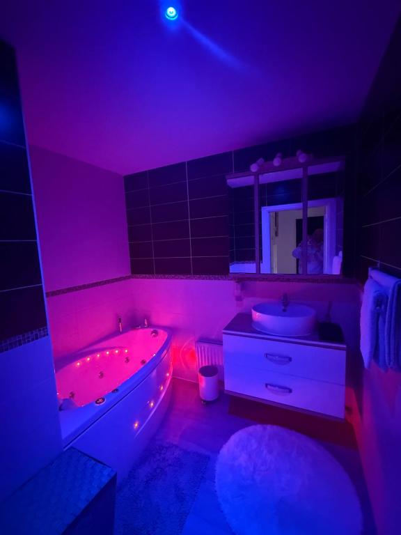 a bathroom with a tub and a sink with red lights at Pied-à-terre de rêve à Marseille - Confort & Style & moderne & équipé & cosy in Marseille