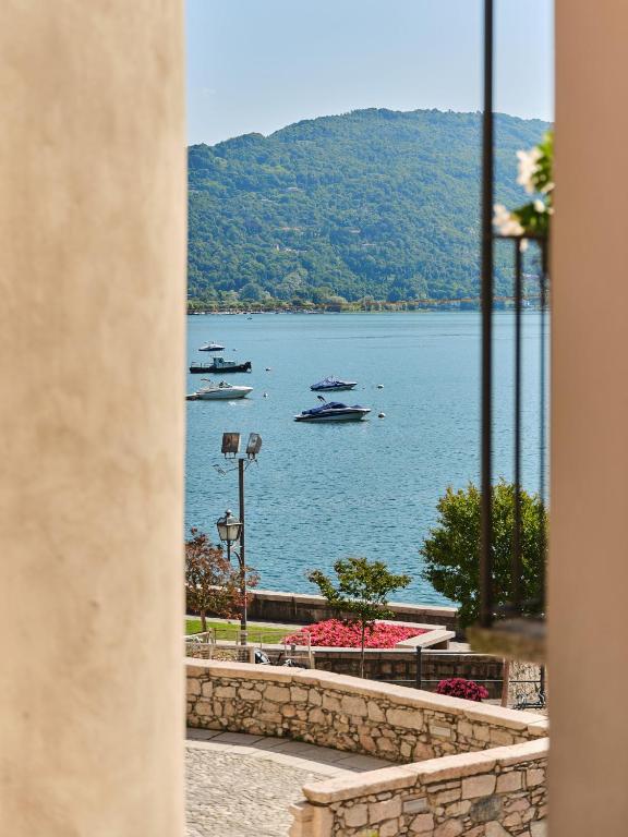 a view of a lake with boats in the water at Appartamento BACCO in Feriolo