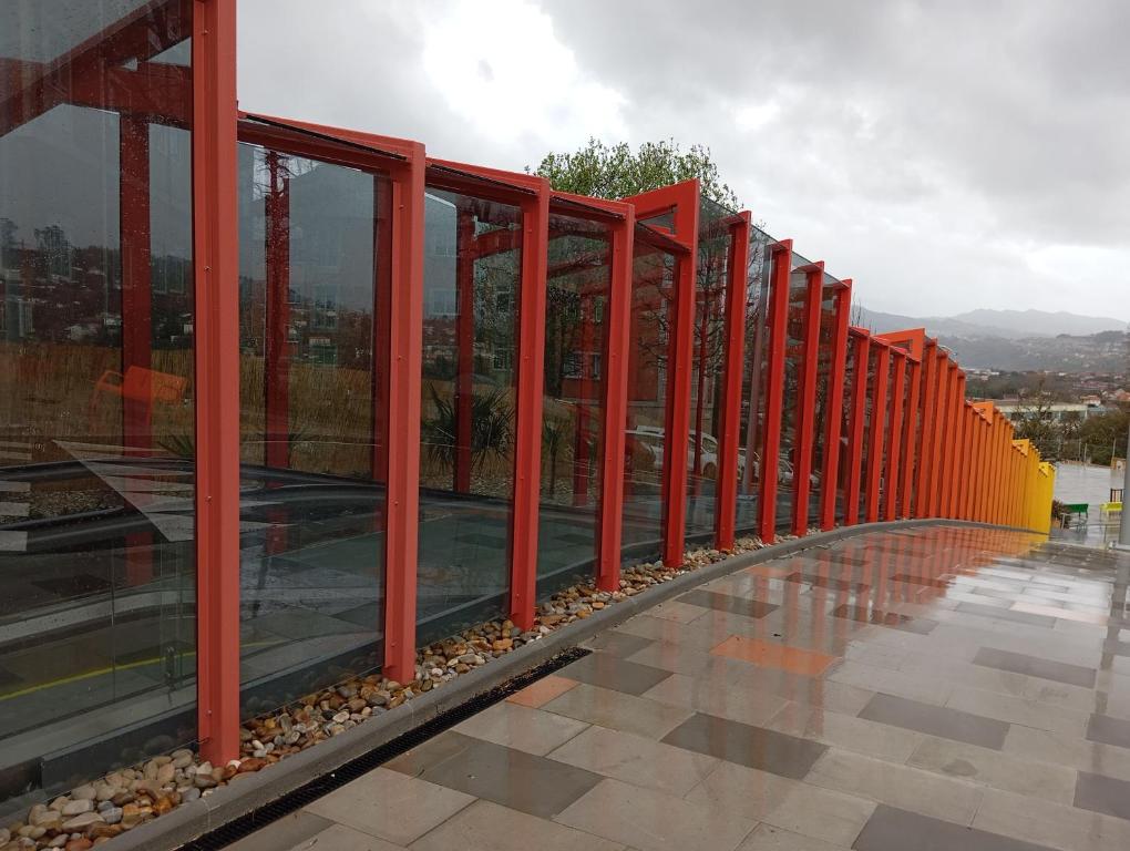 a row of red poles on the side of a building at Apartamento Galeguiña in Vigo