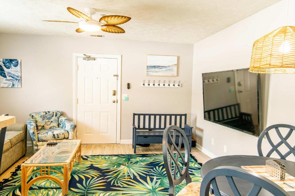 a living room with a couch and a table at Blue Wave Retreat in Heart of Myrtle Beach in Myrtle Beach