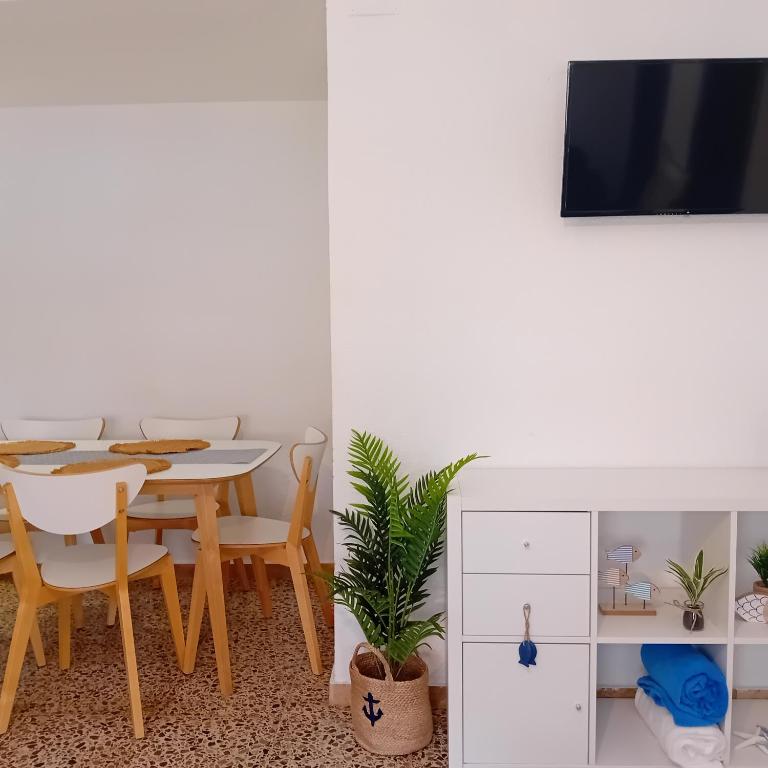 a dining room with a table and a tv at María PLAYA MAR NG in Peniscola
