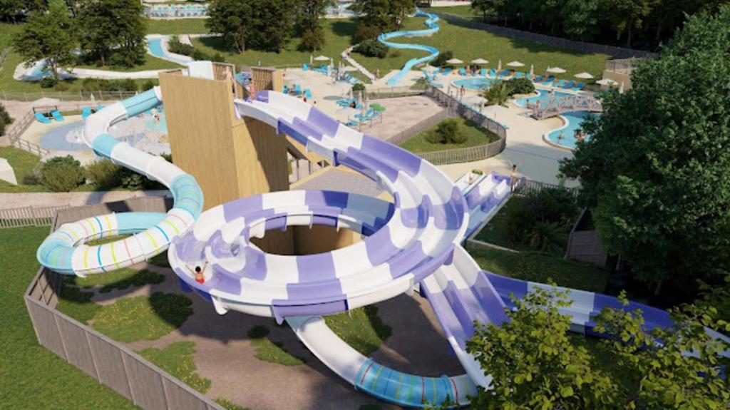 a large water park with a water slide at Camping Saint Avit Loisirs in Journiac