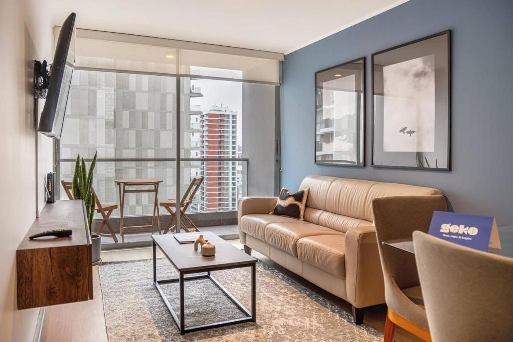 a living room with a couch and a table at Midnight 2BR by Geko in Lima