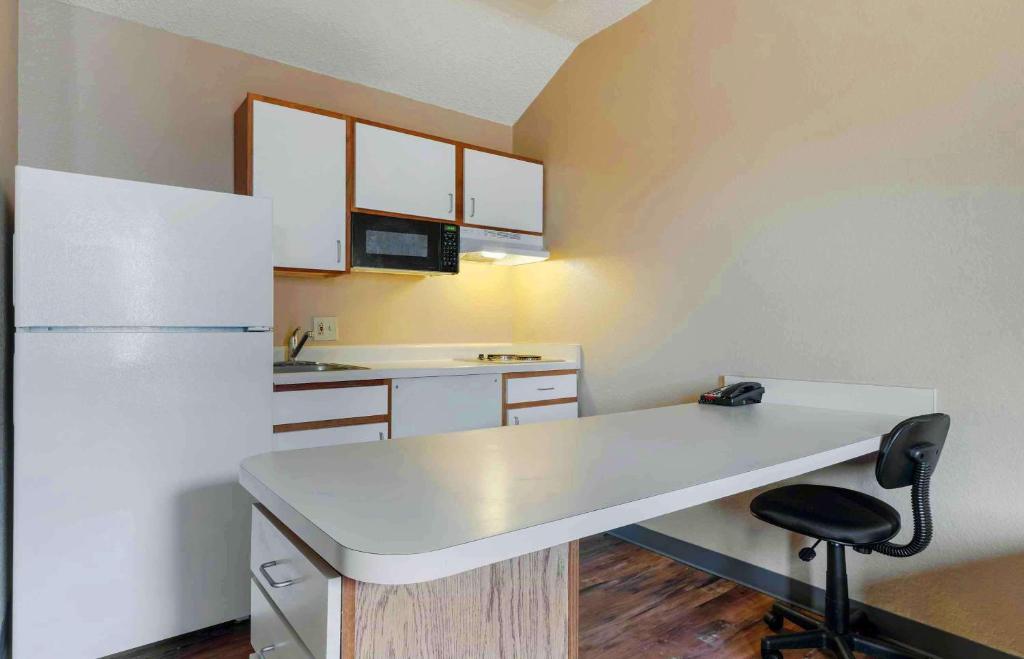 a kitchen with a white counter and a refrigerator at Extended Stay America Select Suites - Orlando - Lake Mary - 1040 Greenwood Blvd in Lake Mary