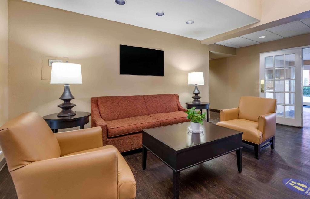 a living room with a couch and chairs and a tv at Extended Stay America Select Suites - Orlando - Lake Mary - 1040 Greenwood Blvd in Lake Mary
