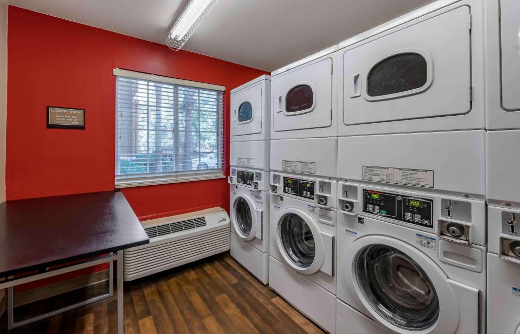 a laundry room with three washing machines in it at Extended Stay America Select Suites - Orlando - Lake Mary - 1040 Greenwood Blvd in Lake Mary