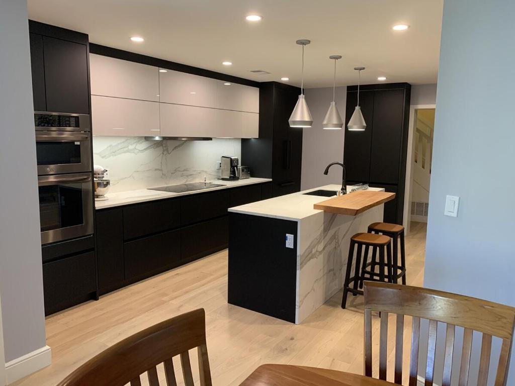 a kitchen with black cabinets and white counter tops at Perfectly Located Luxurious Home in San Francisco