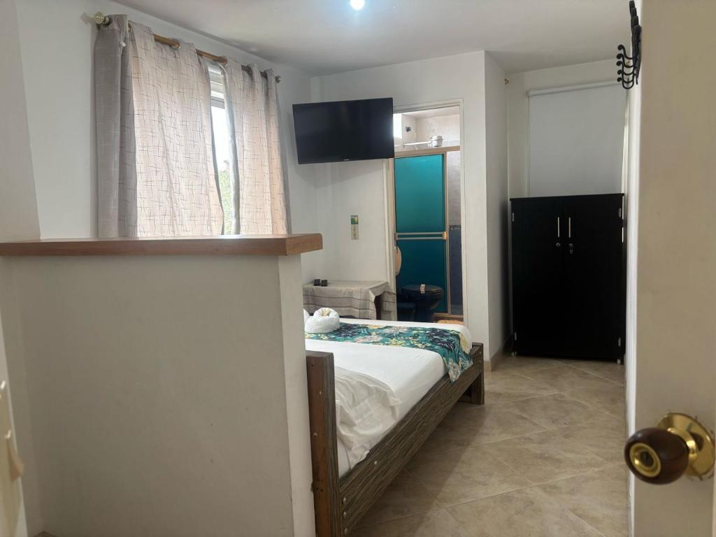 Postel nebo postele na pokoji v ubytování Hotel Portal Guatapé