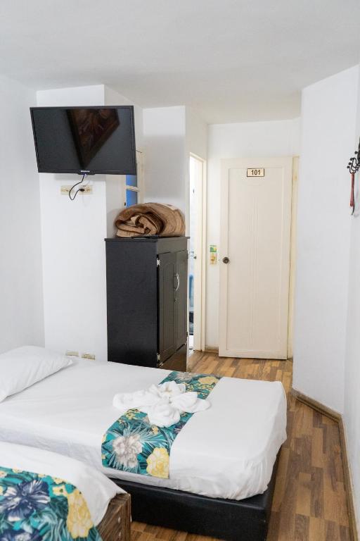 Postel nebo postele na pokoji v ubytování Hotel Portal Guatapé