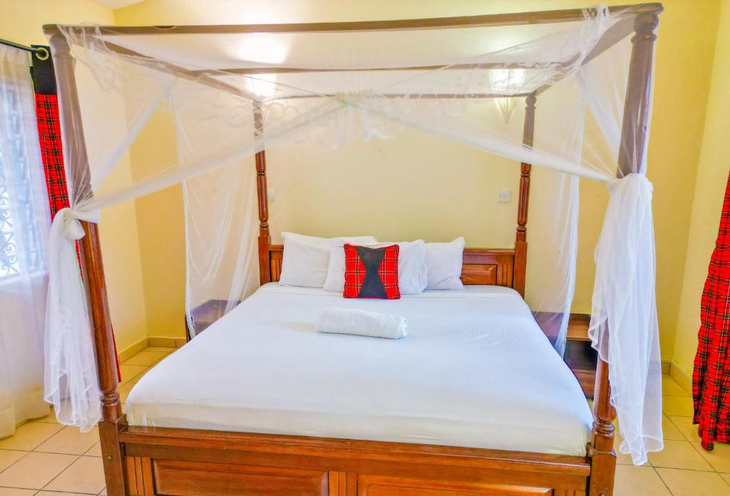Postel nebo postele na pokoji v ubytování Maasai Resort