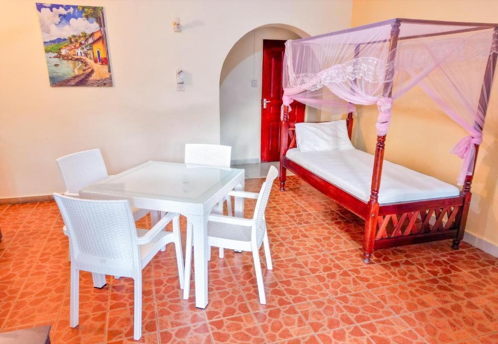 Postel nebo postele na pokoji v ubytování Maasai Resort