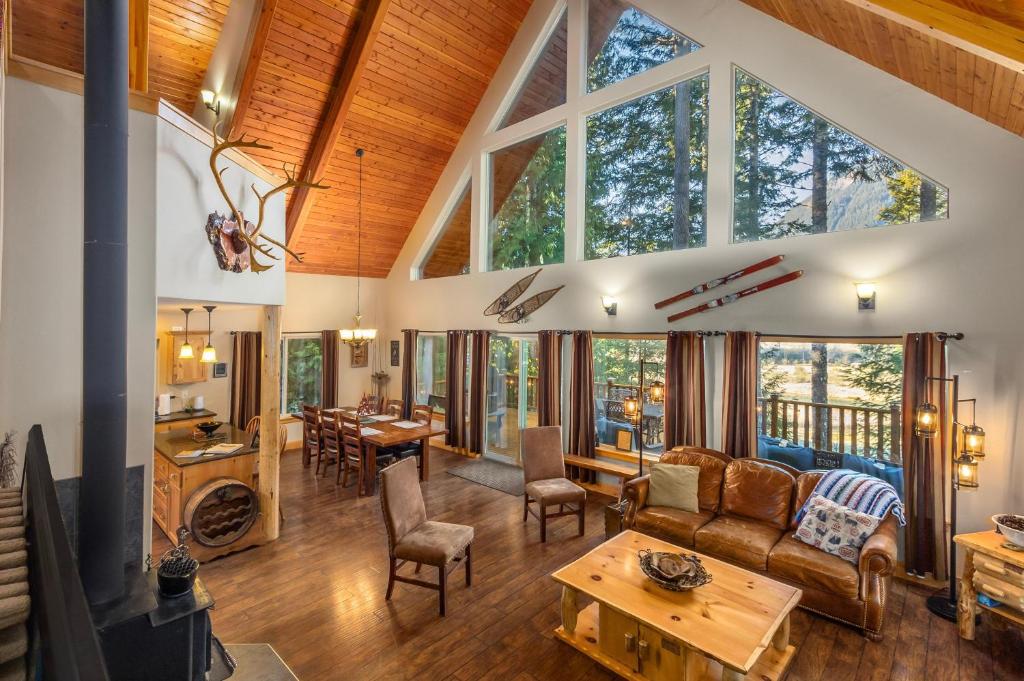 a living room with a couch and a table at `Antler Ridge` Hot tub, Wifi, BBQ, River Access! in Packwood