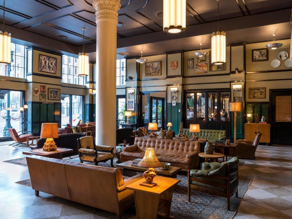 a lobby of a hotel with couches and chairs at Ace Hotel New Orleans in New Orleans