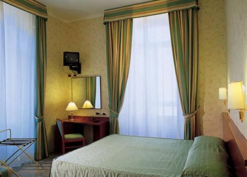 Postel nebo postele na pokoji v ubytování Hotel Dina