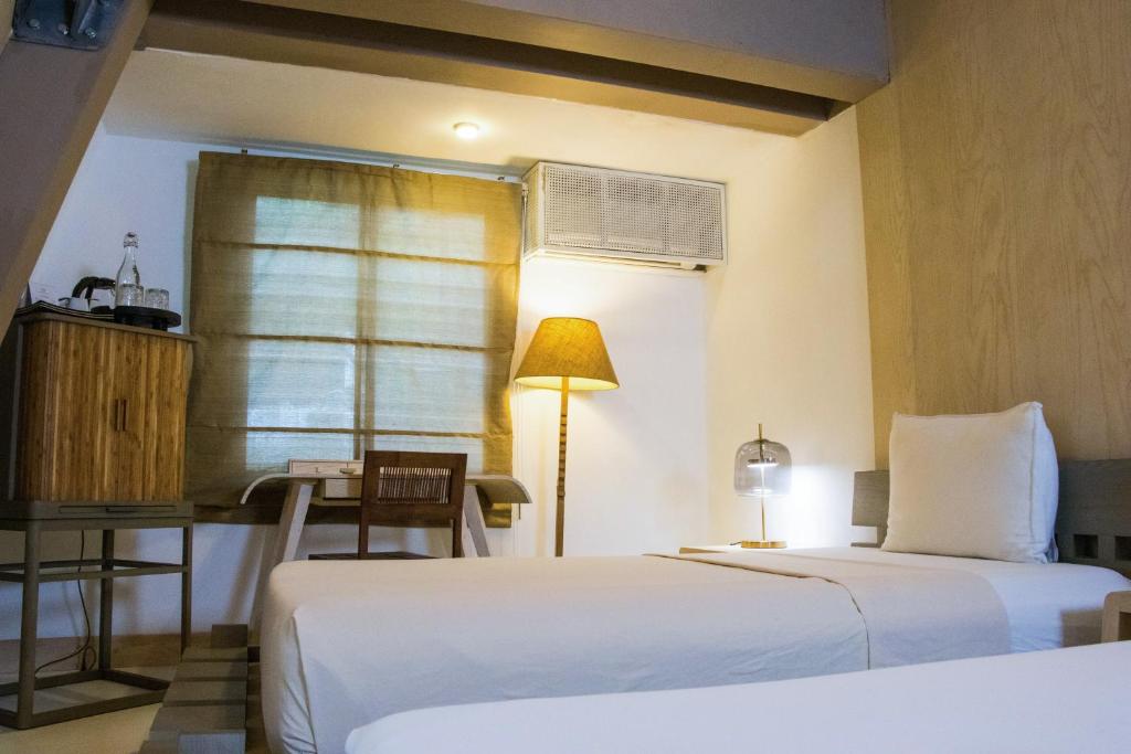 Postel nebo postele na pokoji v ubytování Asmara Urban Resort & Lifestyle Village Powered by ASTON