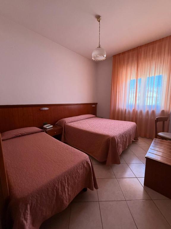 Postel nebo postele na pokoji v ubytování Grifone Hotel