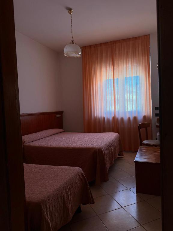 Postel nebo postele na pokoji v ubytování Grifone Hotel