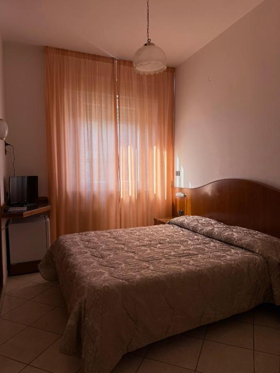 Postel nebo postele na pokoji v ubytování Grifone Hotel