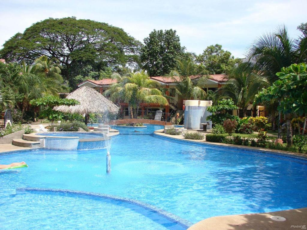 a swimming pool with a fountain in a resort at CocoMarindo in Coco