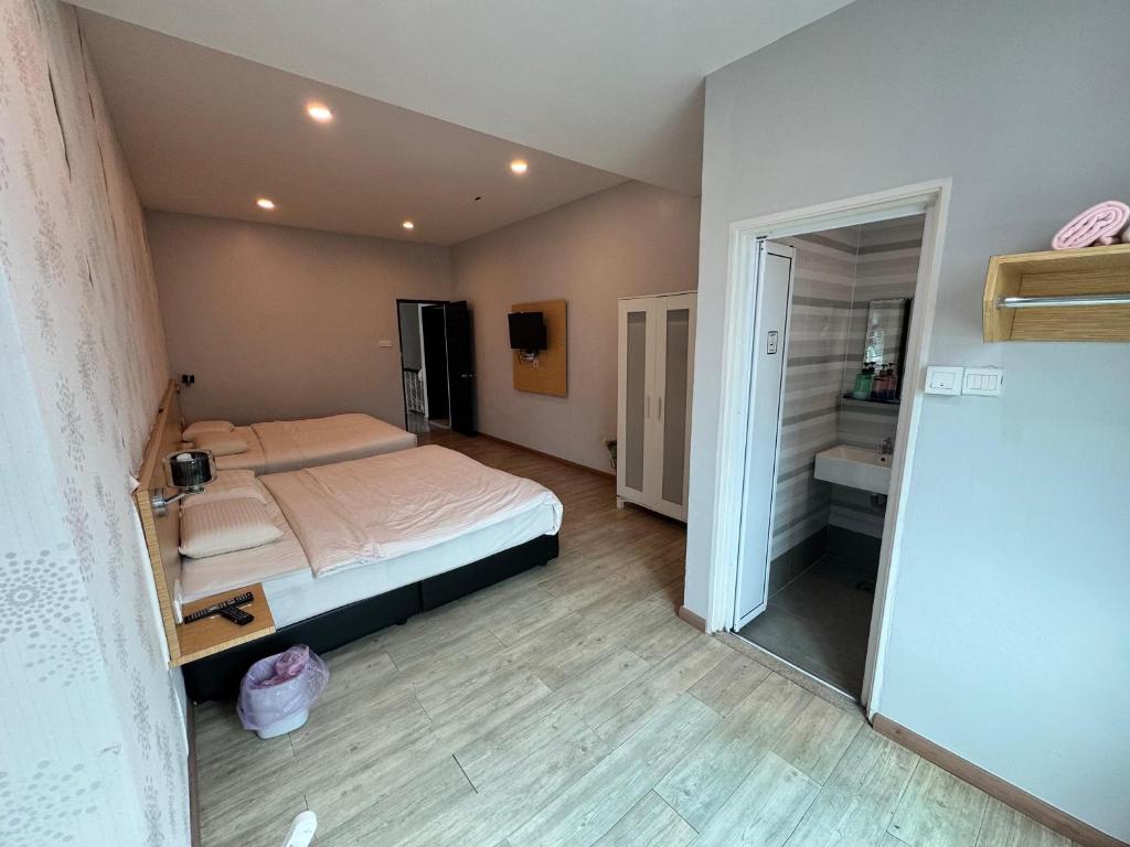 a small bedroom with a bed and a mirror at Tropical villa in Kuantan