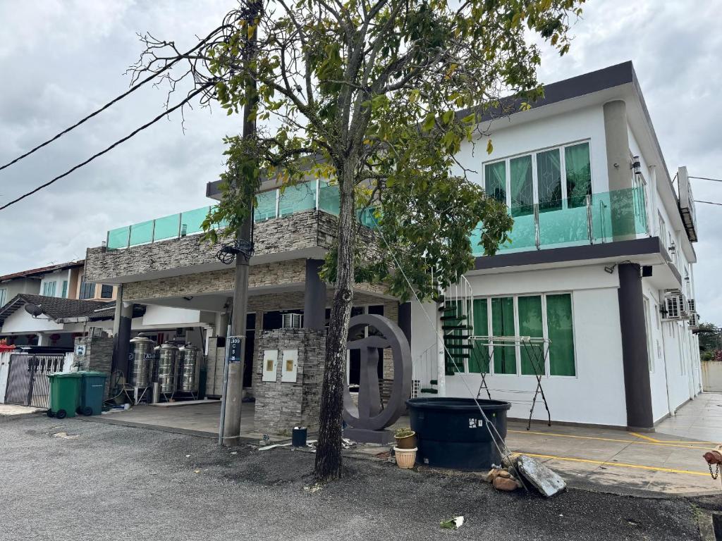 a building with a tree in front of it at Tropical villa in Kuantan