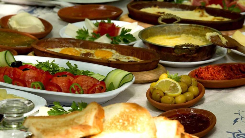 a table with plates of food and bowls of food at ÇANKAYA BOUTiQUE HOTEL in Bahçelievler