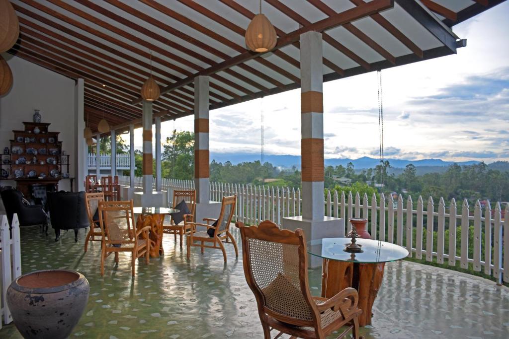 a patio with tables and chairs and a view at Villa Perpetua in Bandarawela