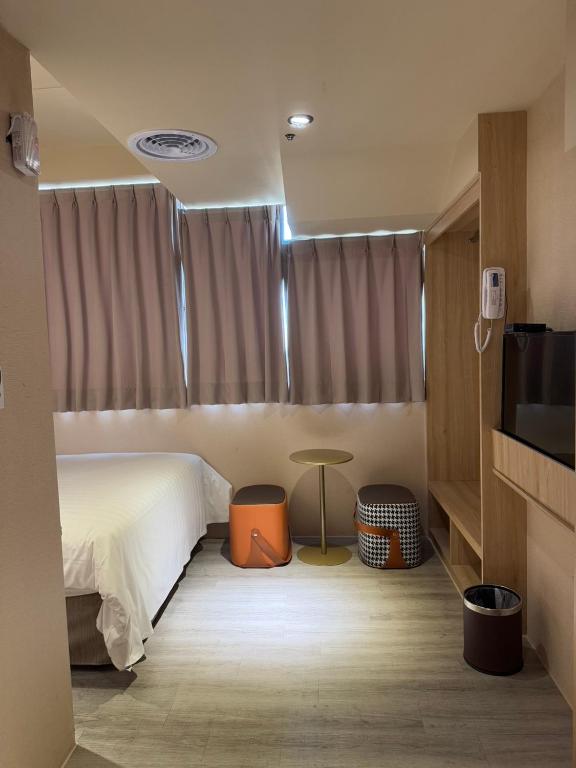 A bed or beds in a room at Rich & Free Hotel - Fuzhong 富逸旅趣-板橋府中館