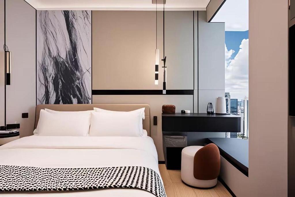 Postel nebo postele na pokoji v ubytování 和樾 City View Hotel - Guangzhou Taikoo Hui Zhujiang New Town Tianhe Sports Cente-Canton Fair