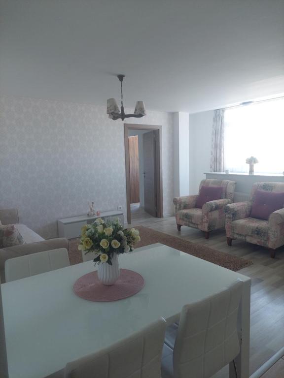 a living room with a table with a vase of flowers on it at MIRO HOUSE in Bucharest