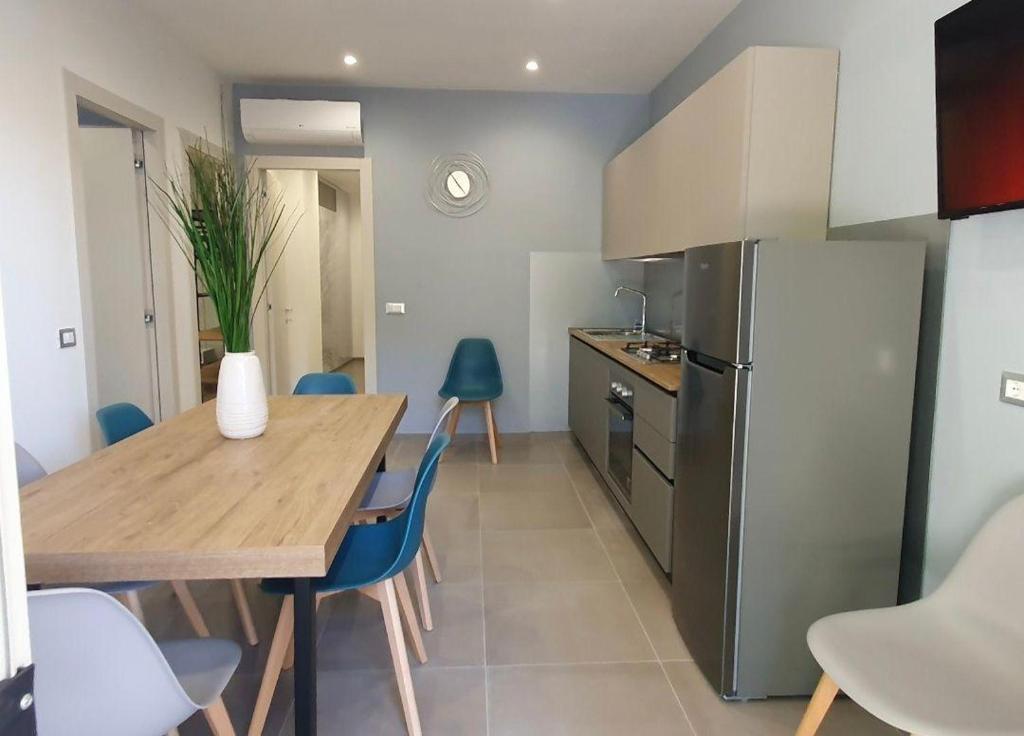 a kitchen with a wooden table and a refrigerator at Playa-degli-Angeli-SCIROCCO in Gabicce Mare