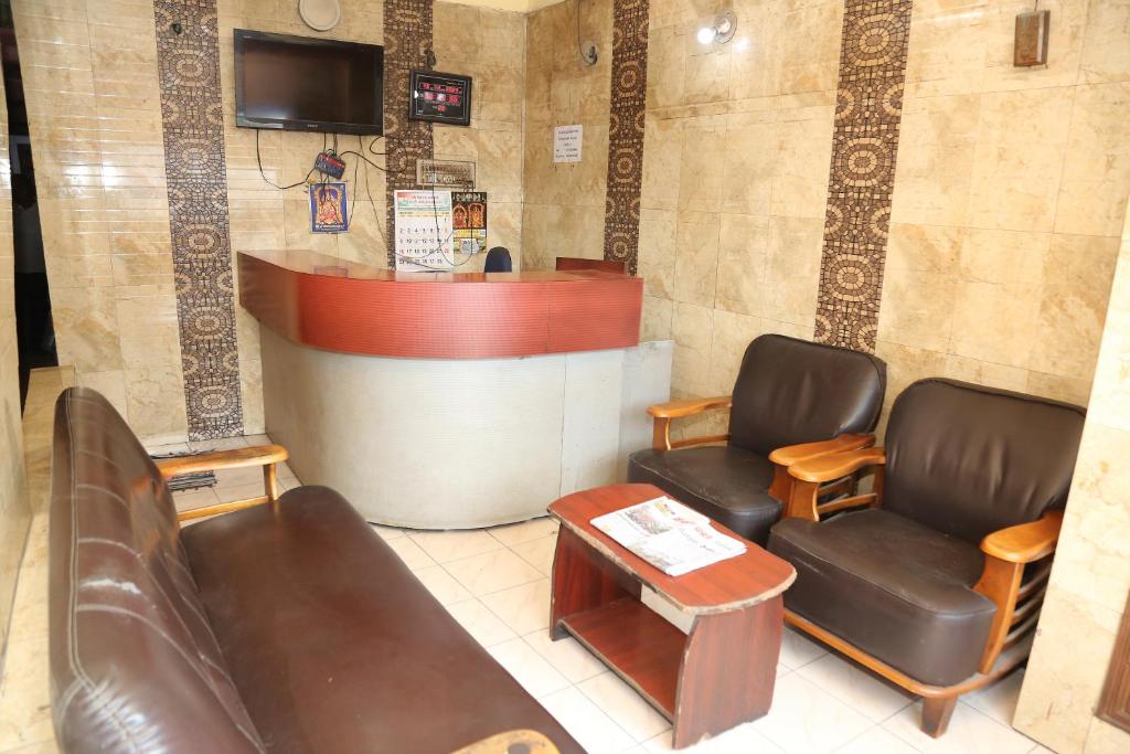 a waiting room with two chairs and a counter at DKS Lodge in Vellore