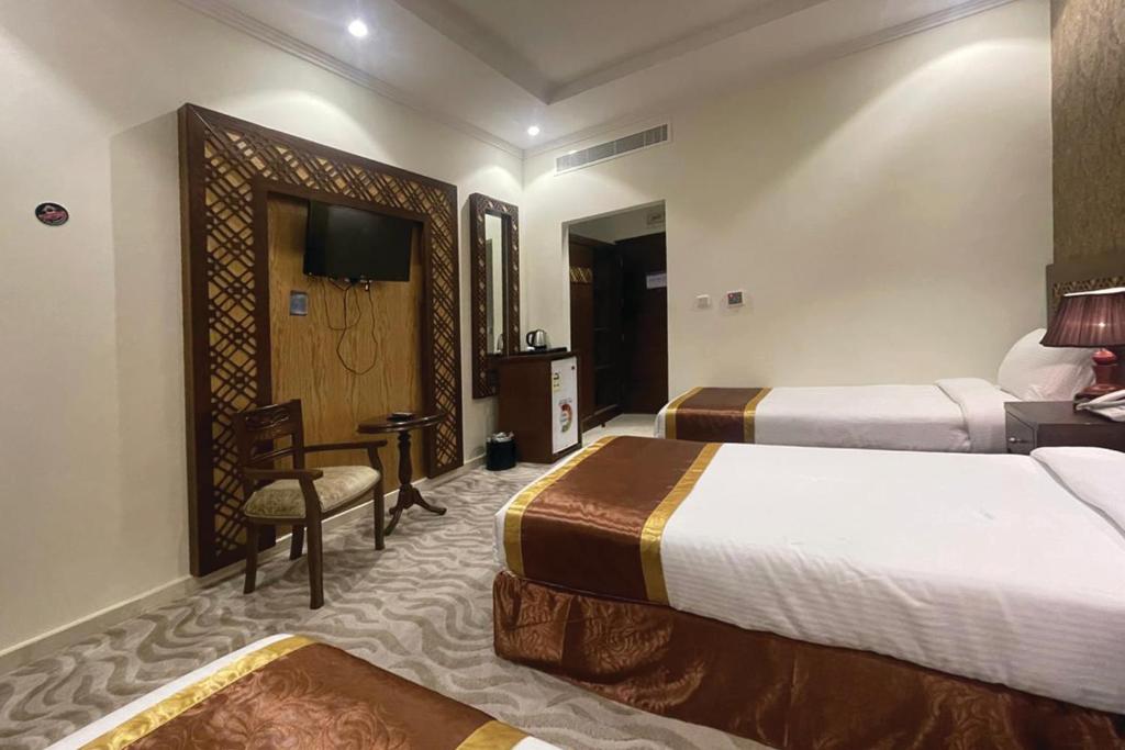 Postel nebo postele na pokoji v ubytování Wadi AlJaryan Hotel