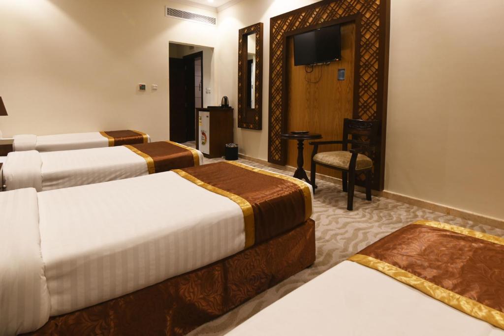 Postel nebo postele na pokoji v ubytování Wadi AlJaryan Hotel