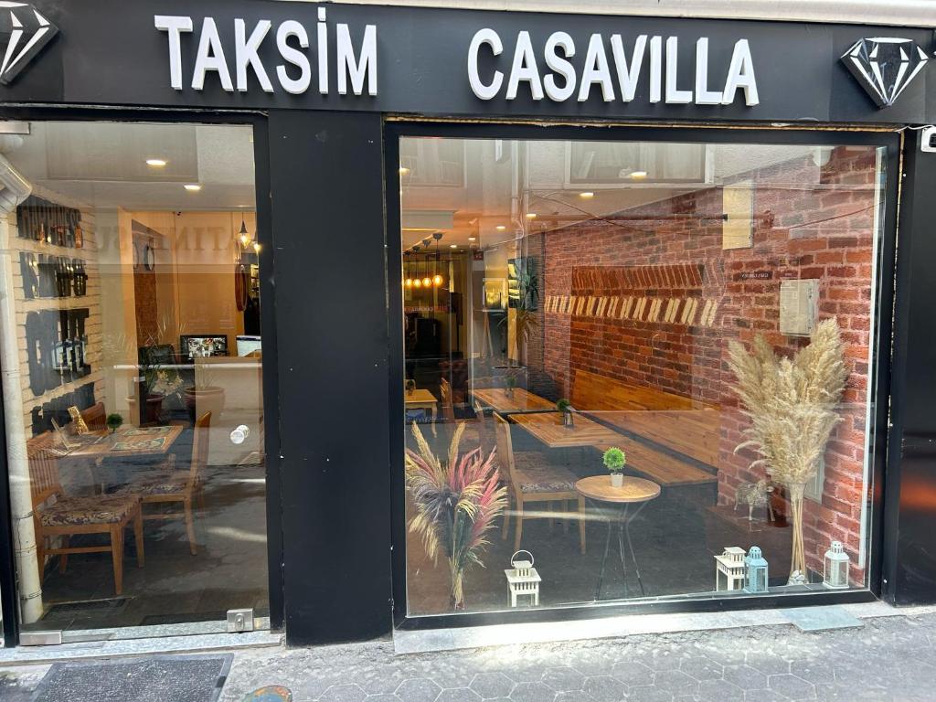 a store front of a restaurant with a table in the window at Istanbul Taksim Istiklal Street CasaVilla Hotel in Istanbul