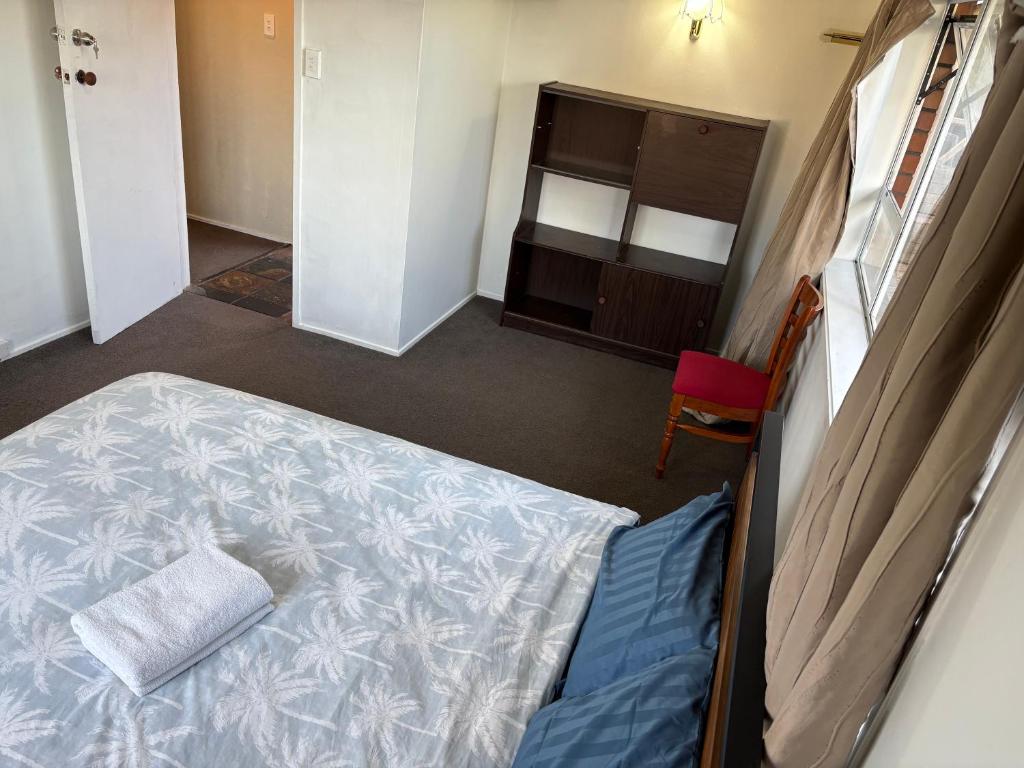 Postel nebo postele na pokoji v ubytování Cheap Guesthouse in New Lynn