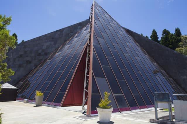 a large pyramidangular building with a lot of windows at Villa Tamara les hauts in Le Tampon