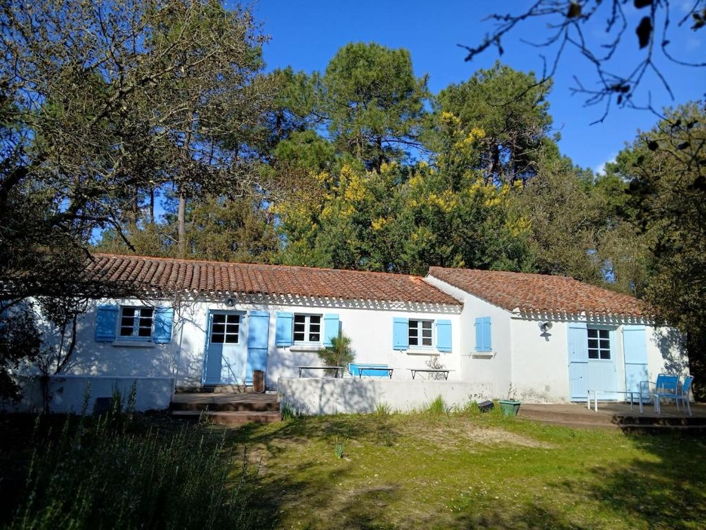 een wit huis met een rood dak bij L'écrin de la Pinède in La Barre-de-Monts