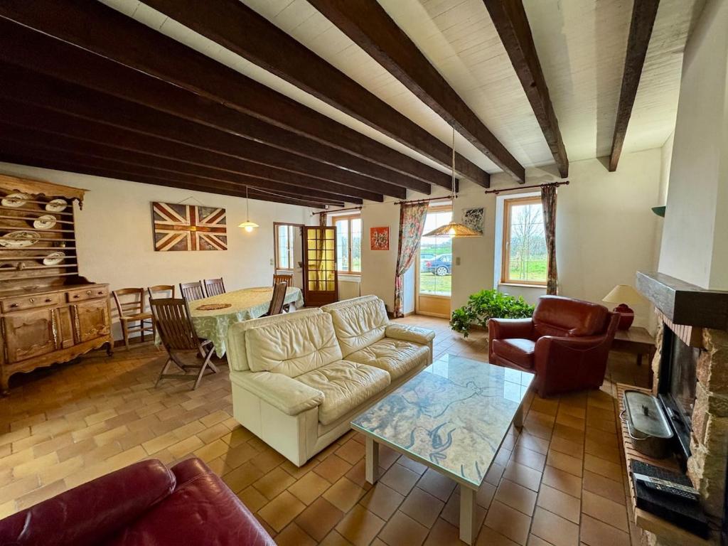 Grande Maison au Calme في La Merlatière: غرفة معيشة بها أريكة وطاولة
