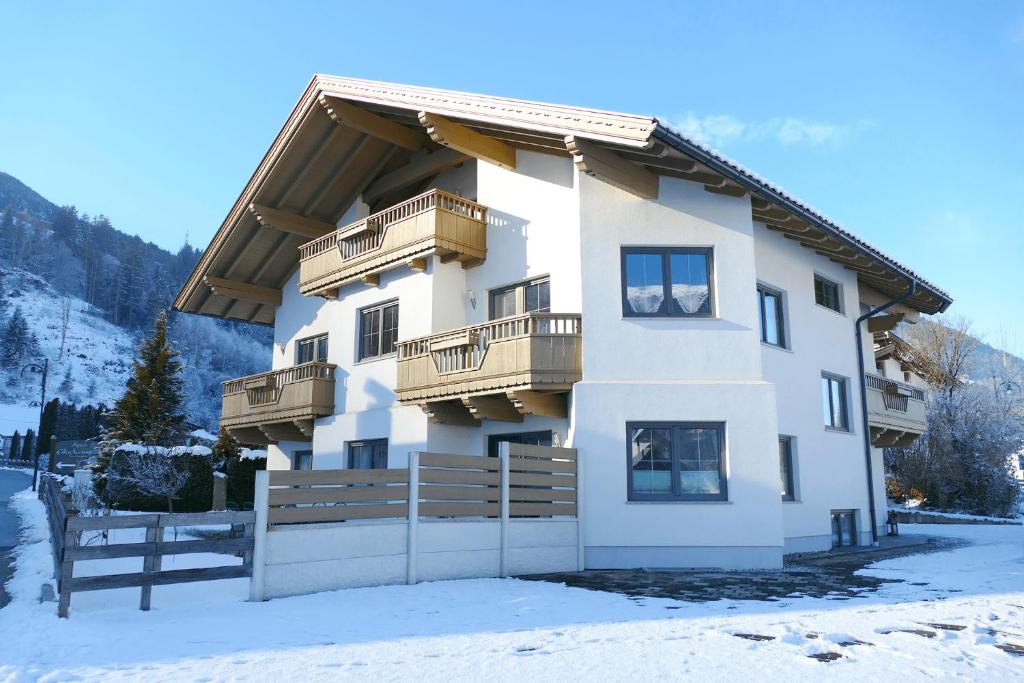 a building with balconies on the side of it in the snow at Ferienhaus Wöscher in Kaltenbach