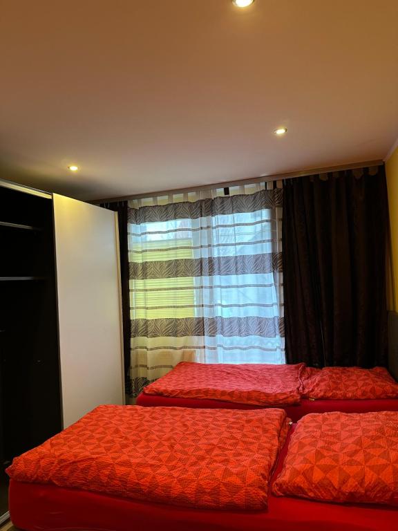 a bedroom with two beds in front of a window at CASA Del SUR in Braunschweig