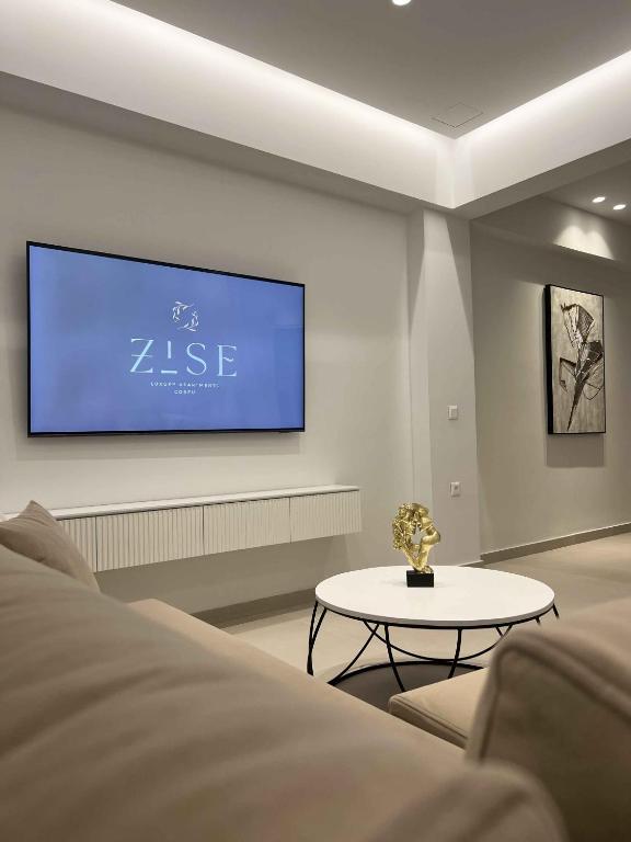 a living room with a tv on a wall at ZISE Luxury Apartments in Corfu