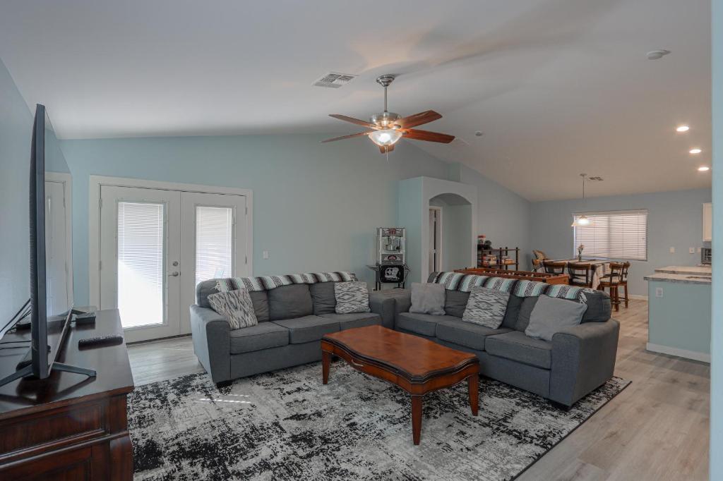 a living room with two couches and a flat screen tv at NEW! Family and Dog Friendly Maricopa Home with Grill & Patio in Maricopa