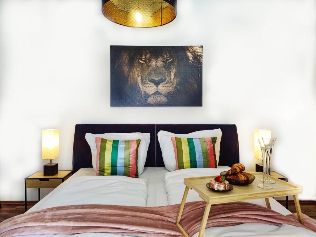 a bedroom with a bed with a lion picture on the wall at Modernes Loft-Erlebnis mit Fitnessbereich & Heimkino in Magdeburg